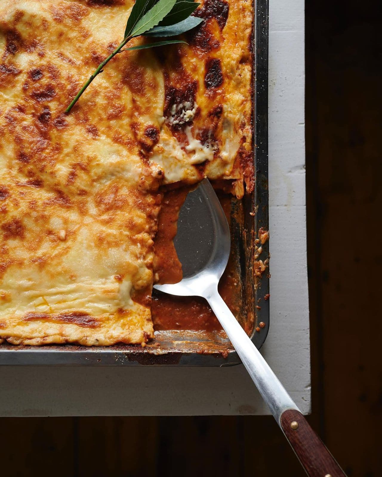Golden baked lasagna with layers of fresh egg pasta, bechamel and parmigiano reggiano