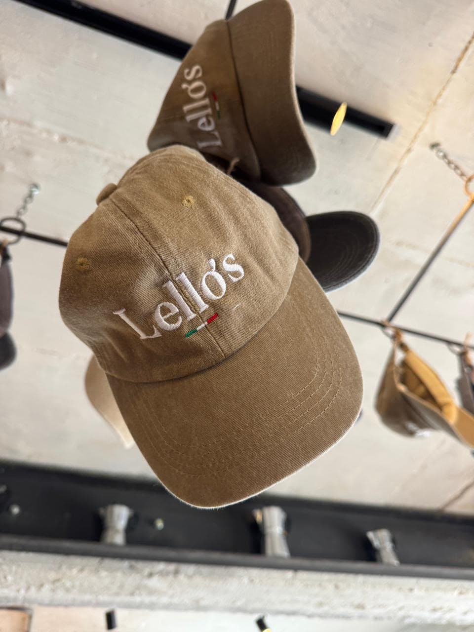Lello's embroidered caps hanging from the trattoria ceiling