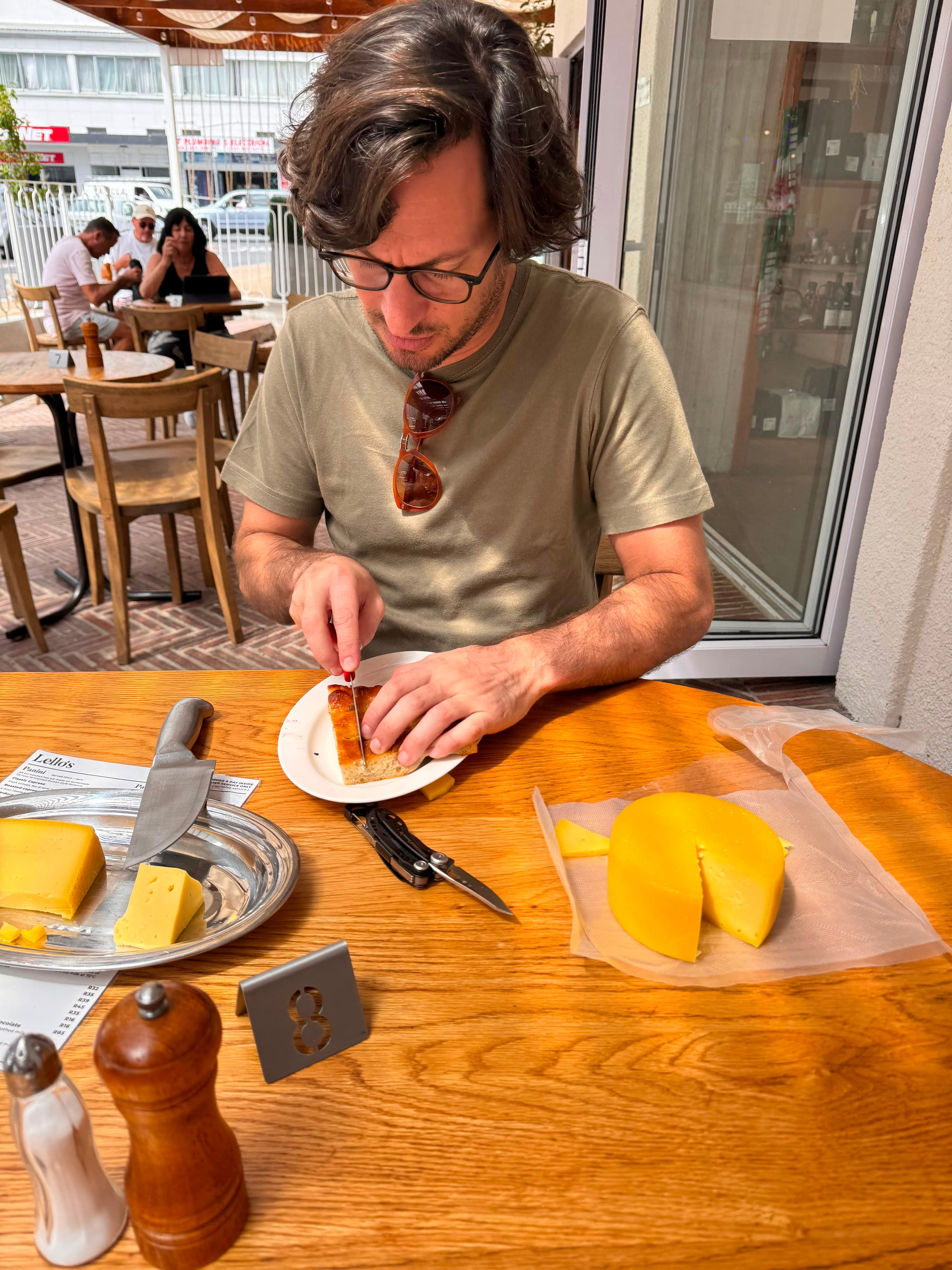 Guest enjoying lunch on the terrace with provolone and cheese boards on the table
