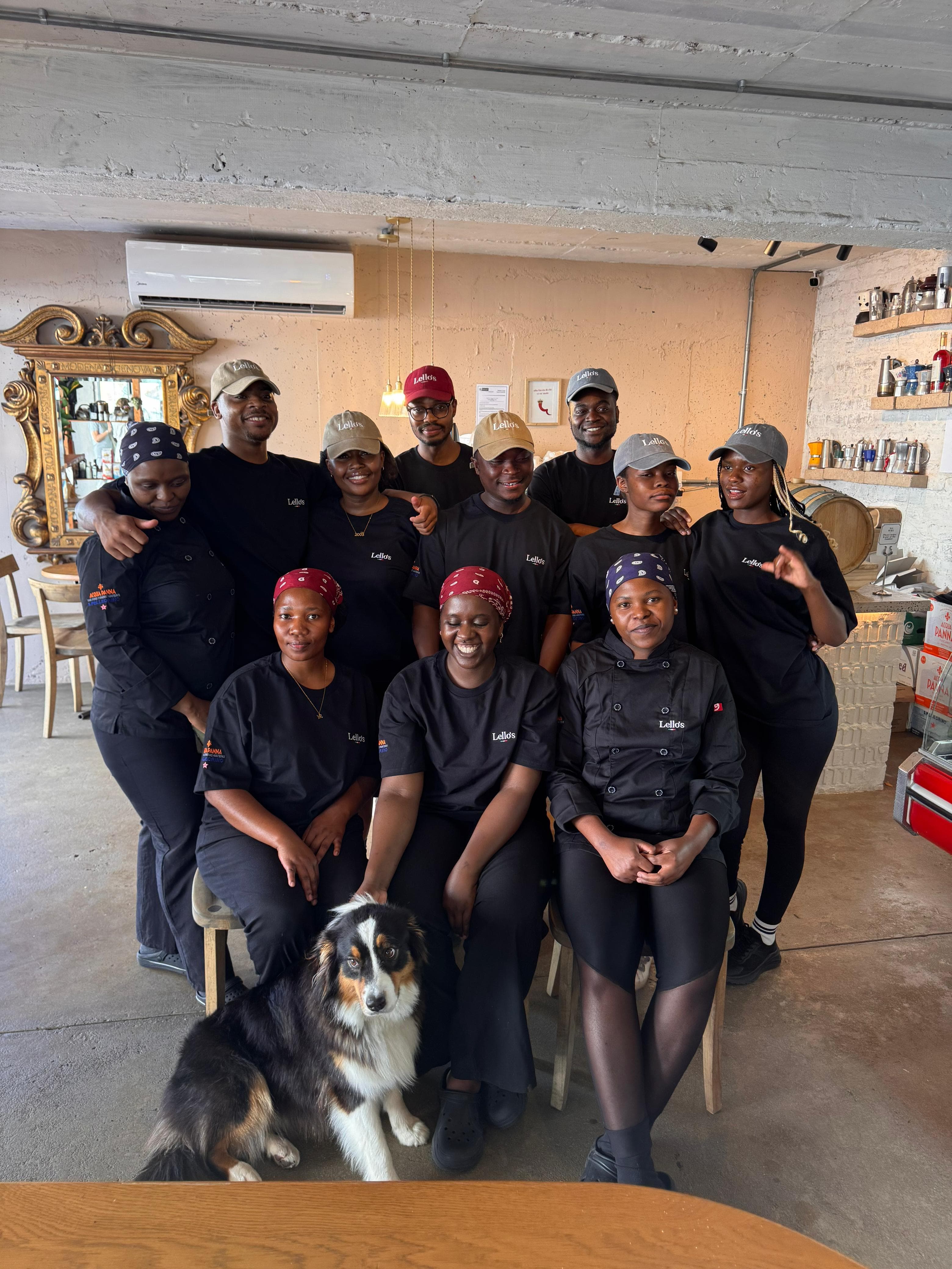 The full Lello's staff gathered for a group photo with Nila the golden retriever